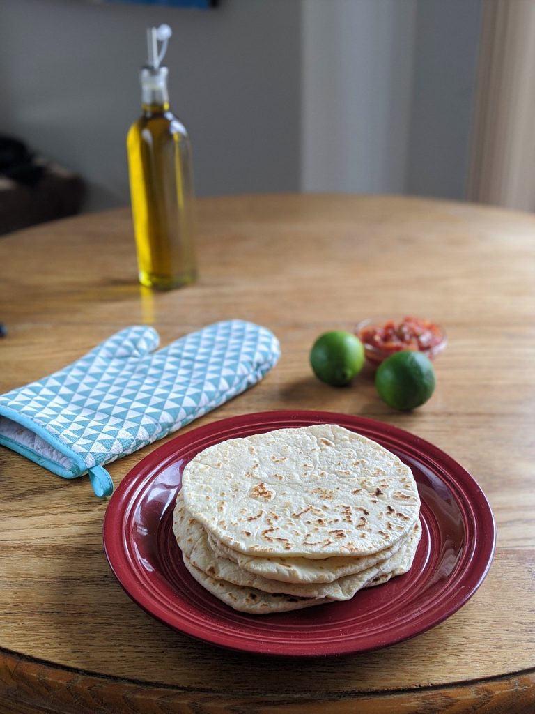 Stack of flour tortilla on a red plate 