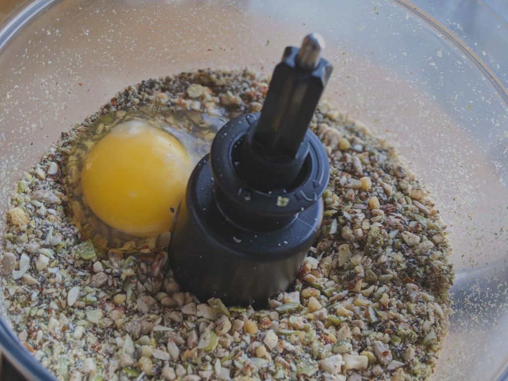 Adding an egg to the processed nut mixture