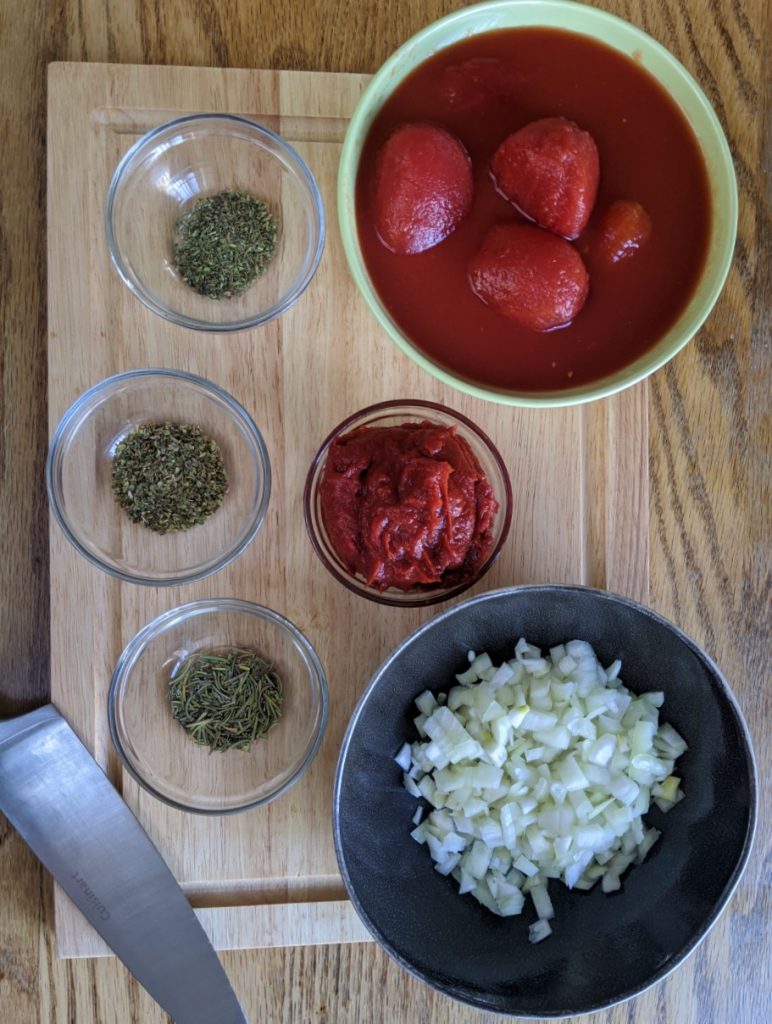 Raw ingredients for dehydrated veggie backcountry bolognese dish -  tomatoes, tomato paste, herbs, diced onions