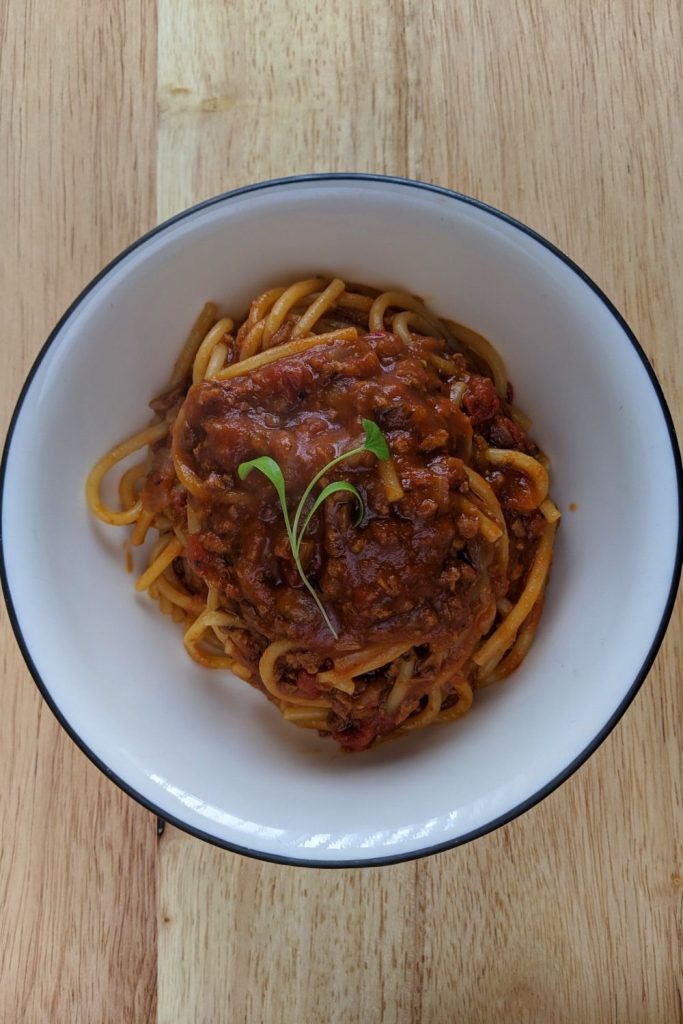 Vegetarian backcountry bolognese - finished dish in white bowl on table